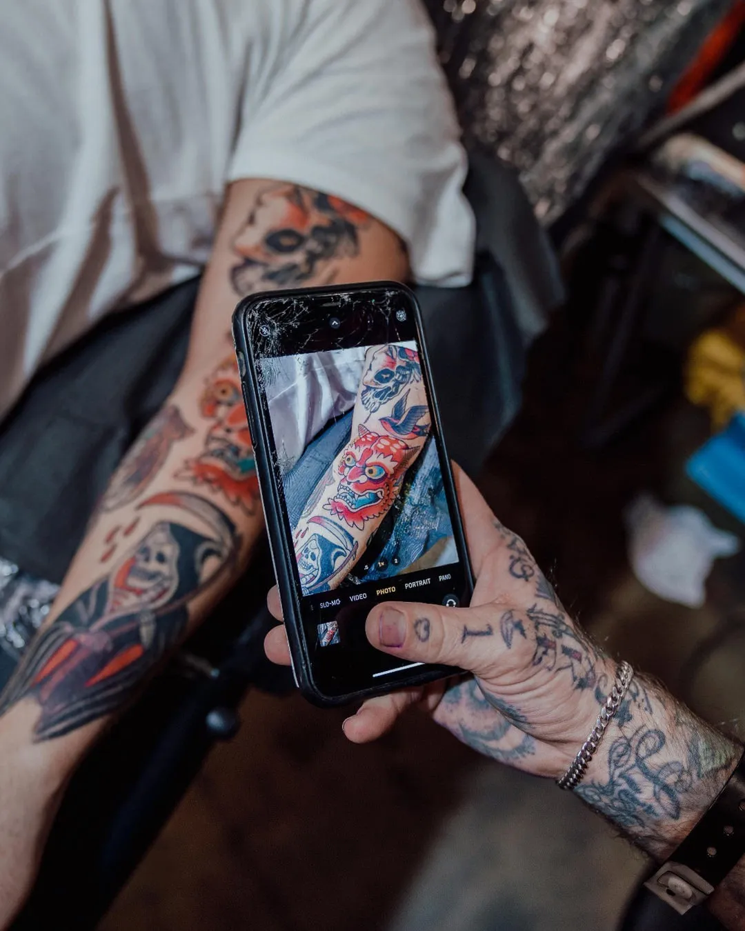 Close-up of a tattoo artist working on a detailed arm design at the Australian Tattoo Expo