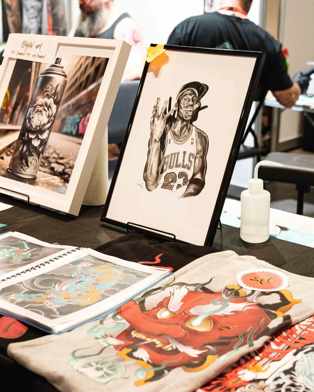 Tattoo artwork and prints displayed for sale at an artist booth during the Australian Tattoo Expo