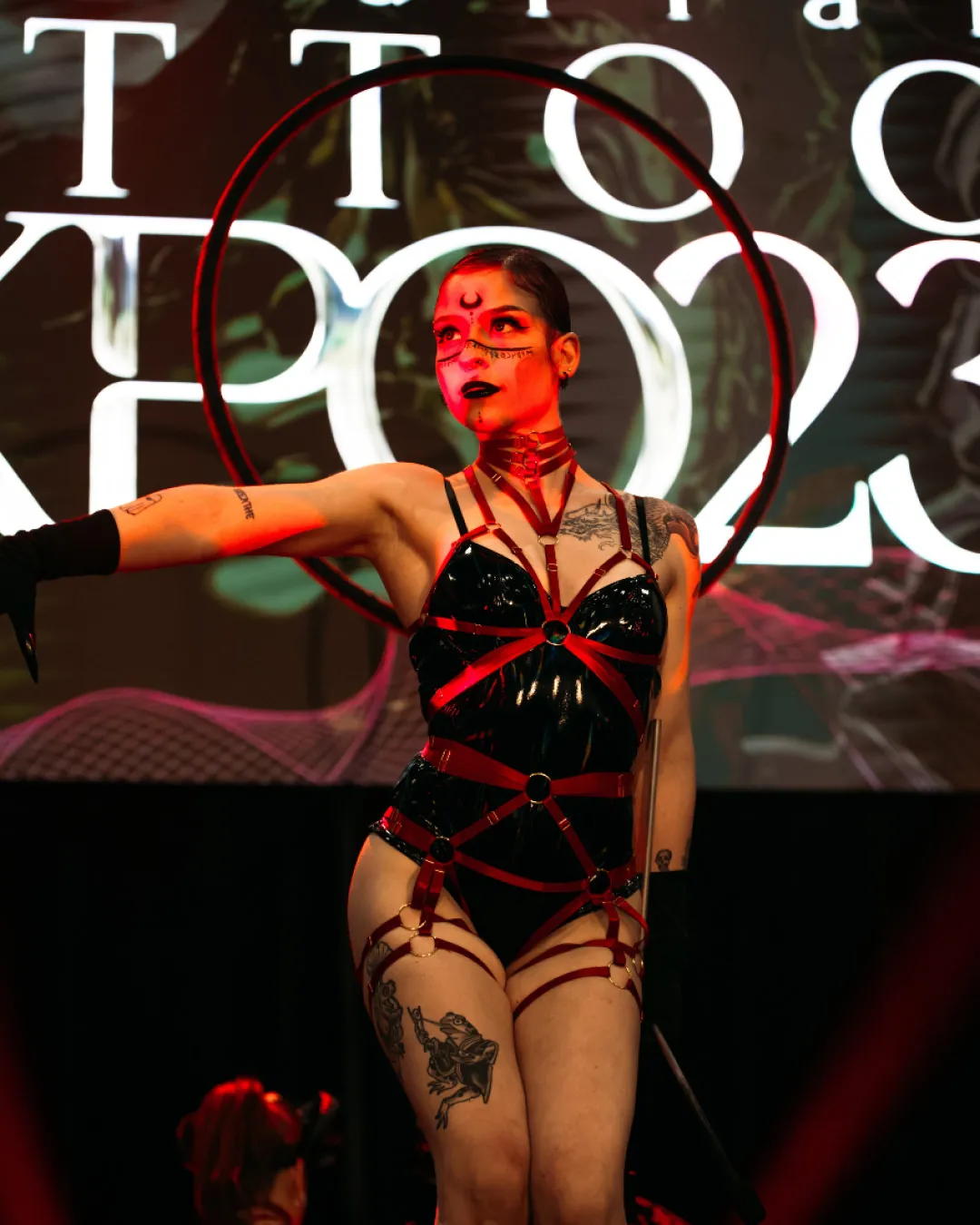 Burlesque performer entertaining the crowd on stage at the Australian Tattoo Expo