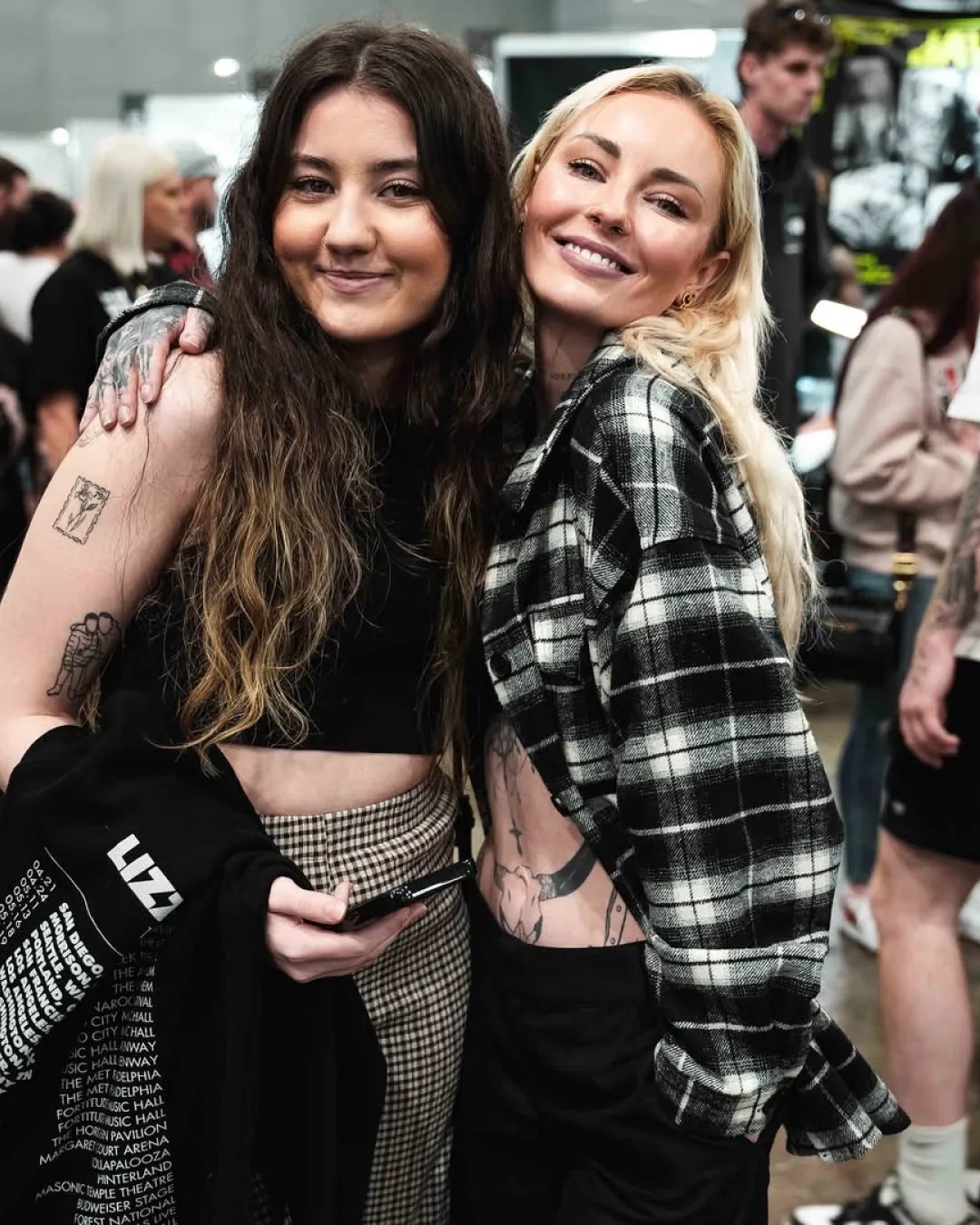 Expo visitor friends smiling and showing fresh tattoos inside the Australian Tattoo Expo