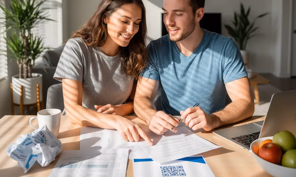 Couple reviewing utility bills for iQRATE Mortgages