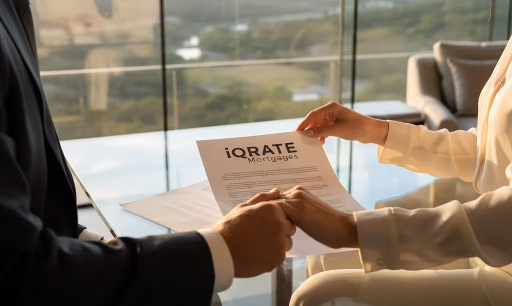 Couple reviewing iQRATE Mortgages document in luxury home.