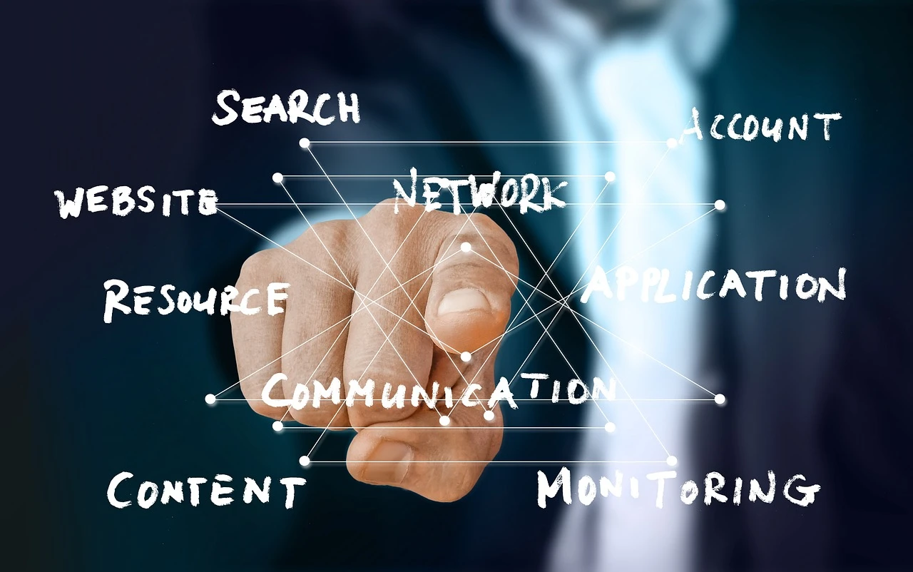 Businessman pointing at virtual interface with keywords like network, website, content, and communication.