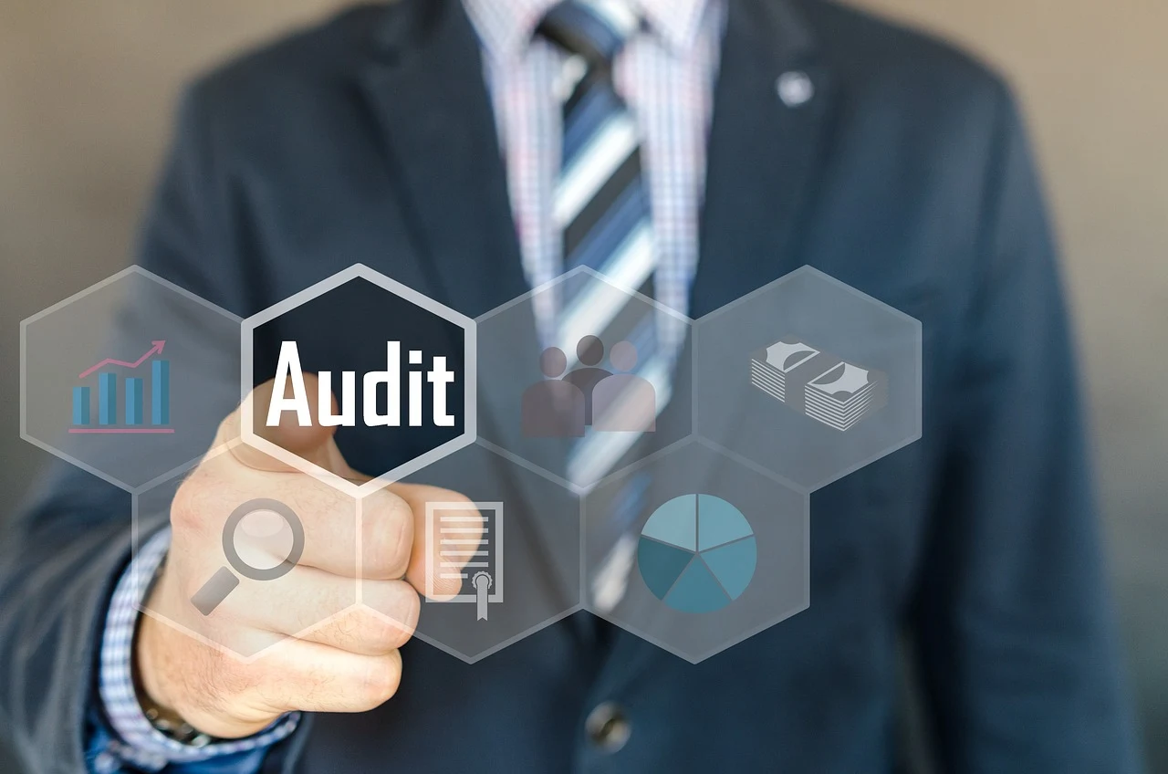 Businessman pressing Audit button with icons for UX Audit Services, including charts and documents.