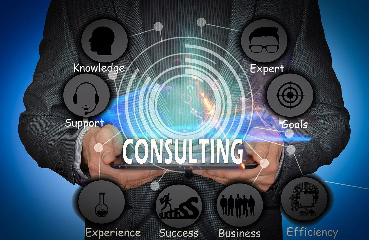 Consulting infographic with hands holding a tablet, featuring icons for knowledge, support, expert, goals, experience, success, business, and efficiency, with UX Consultant focus.