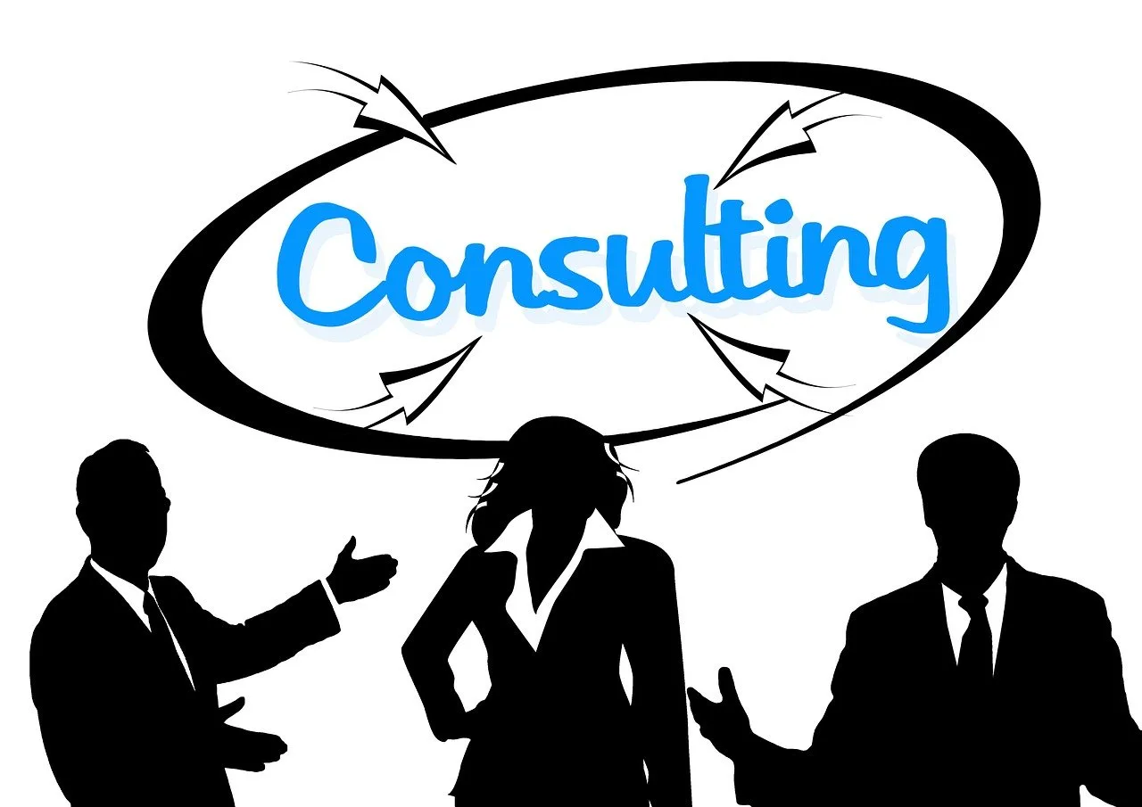 Silhouette of three professionals with 'Consulting' text above, symbolizing teamwork and expertise in a business environment.