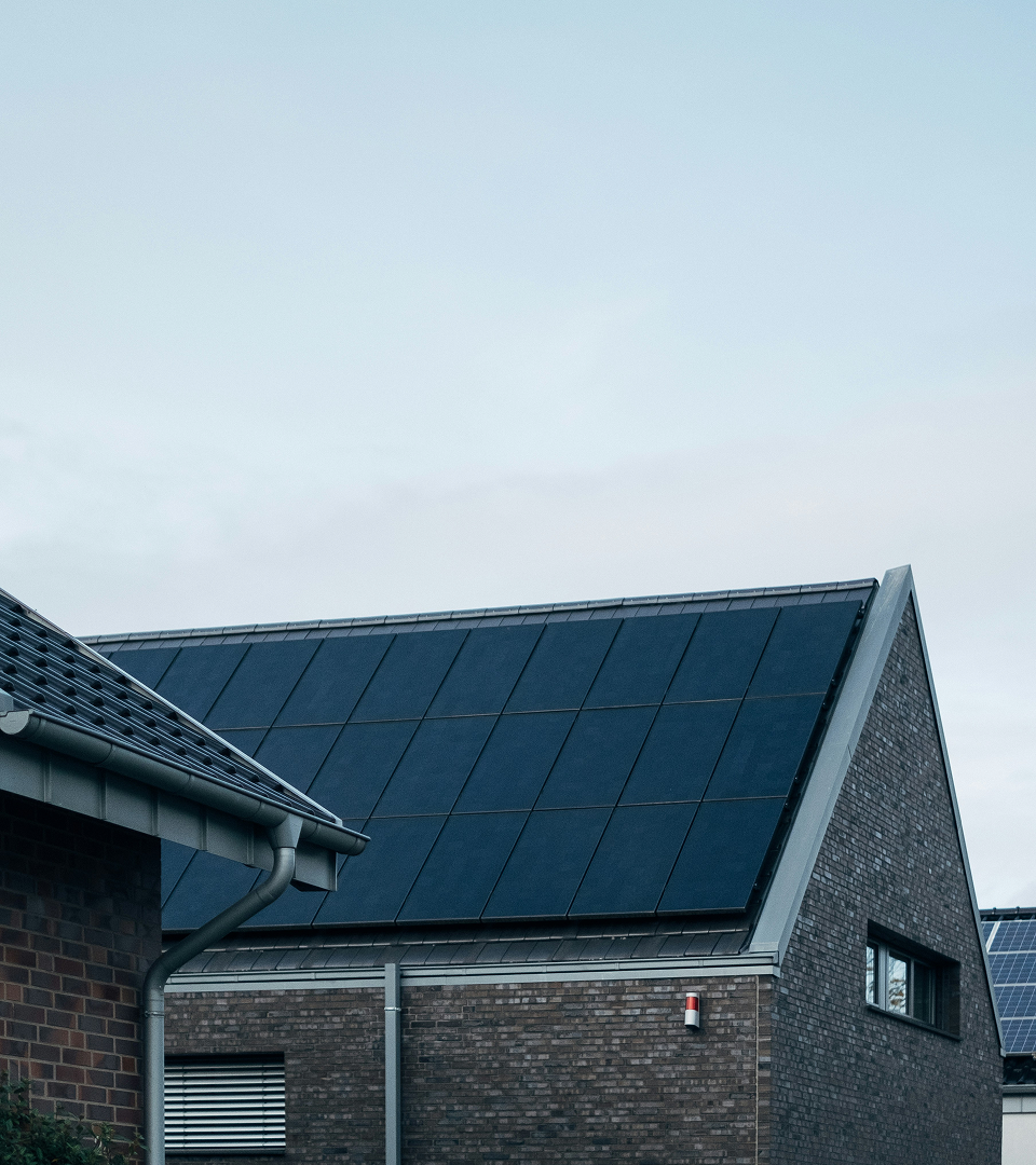 House with pitched roof and all-black Taylor solar panels
