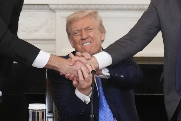 President Donald Trump, center, shakes hands with Armenian Prime Minister Nikol Pashinyan, right, and Azerbaijan President Ilham Aliyev during a trilateral signing ceremony in the State Dining Room of the White House, Friday, Aug. 8, 2025, in Washington. (AP Photo/Mark Schiefelbein)