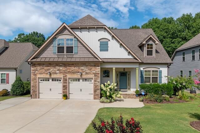 A large house with a driveway in front of it.