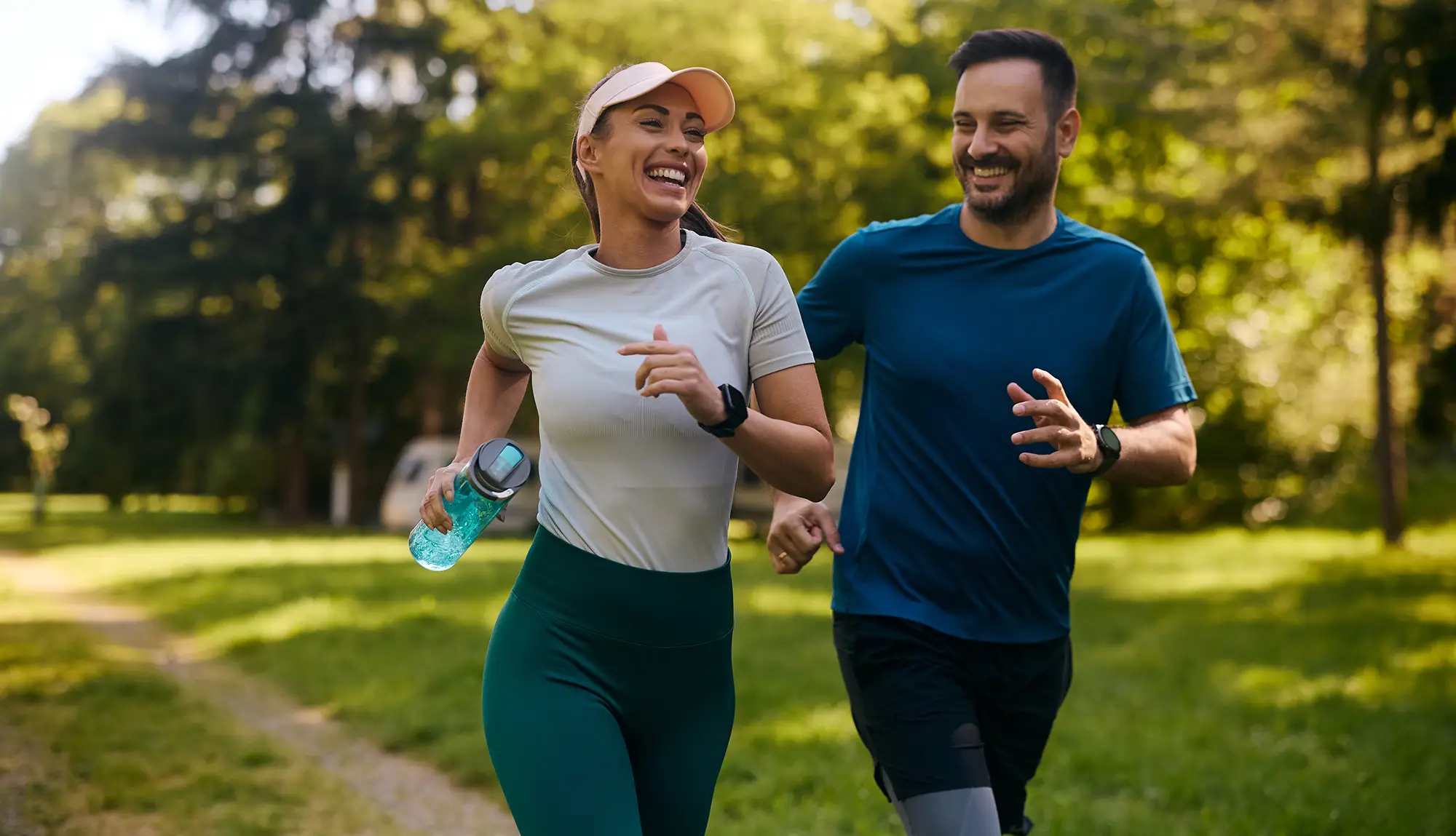 Young, happy couple jogging in the park.