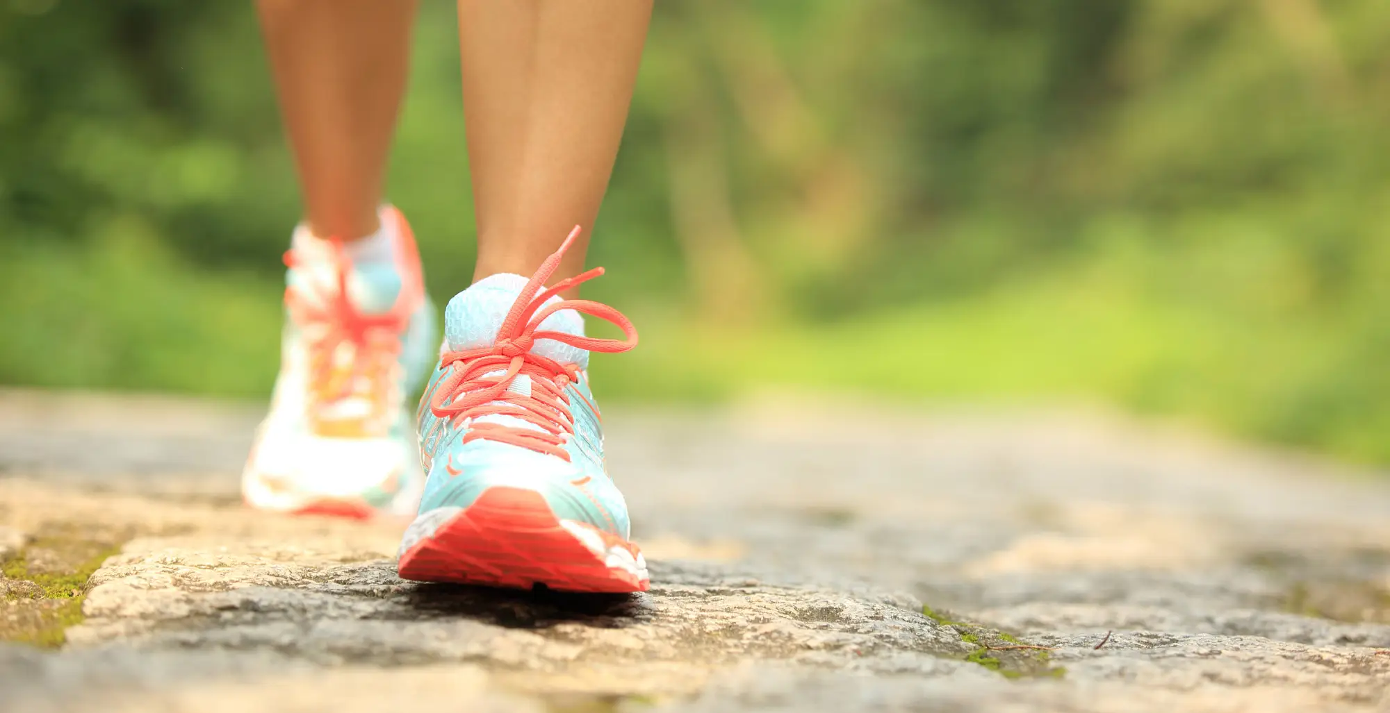 Feet of a woman wearing sport shoes in a park