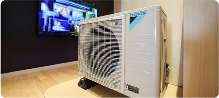 Daikin air conditioning unit with blurred display screen in background