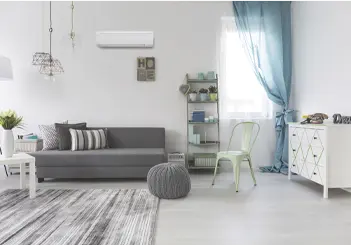 Minimalist living room with gray sofa, white walls, and blue curtain