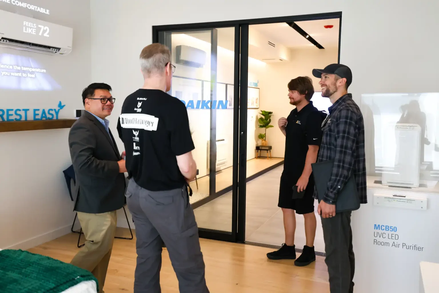 Daikin employees discussing air conditioning in modern showroom