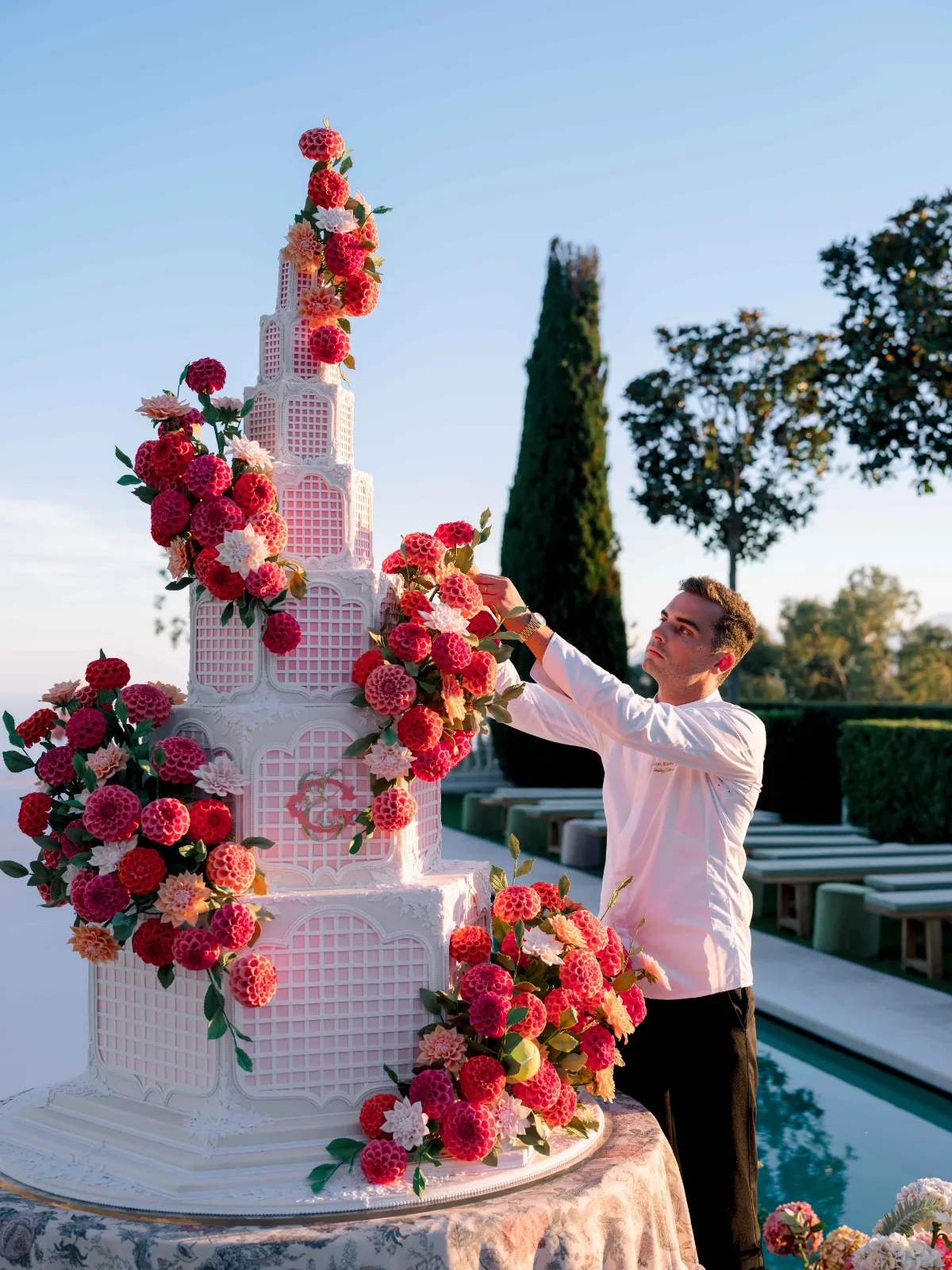 the chef bastien blanc-tailleur adorned a wedding cake with dahlia sugar flowers