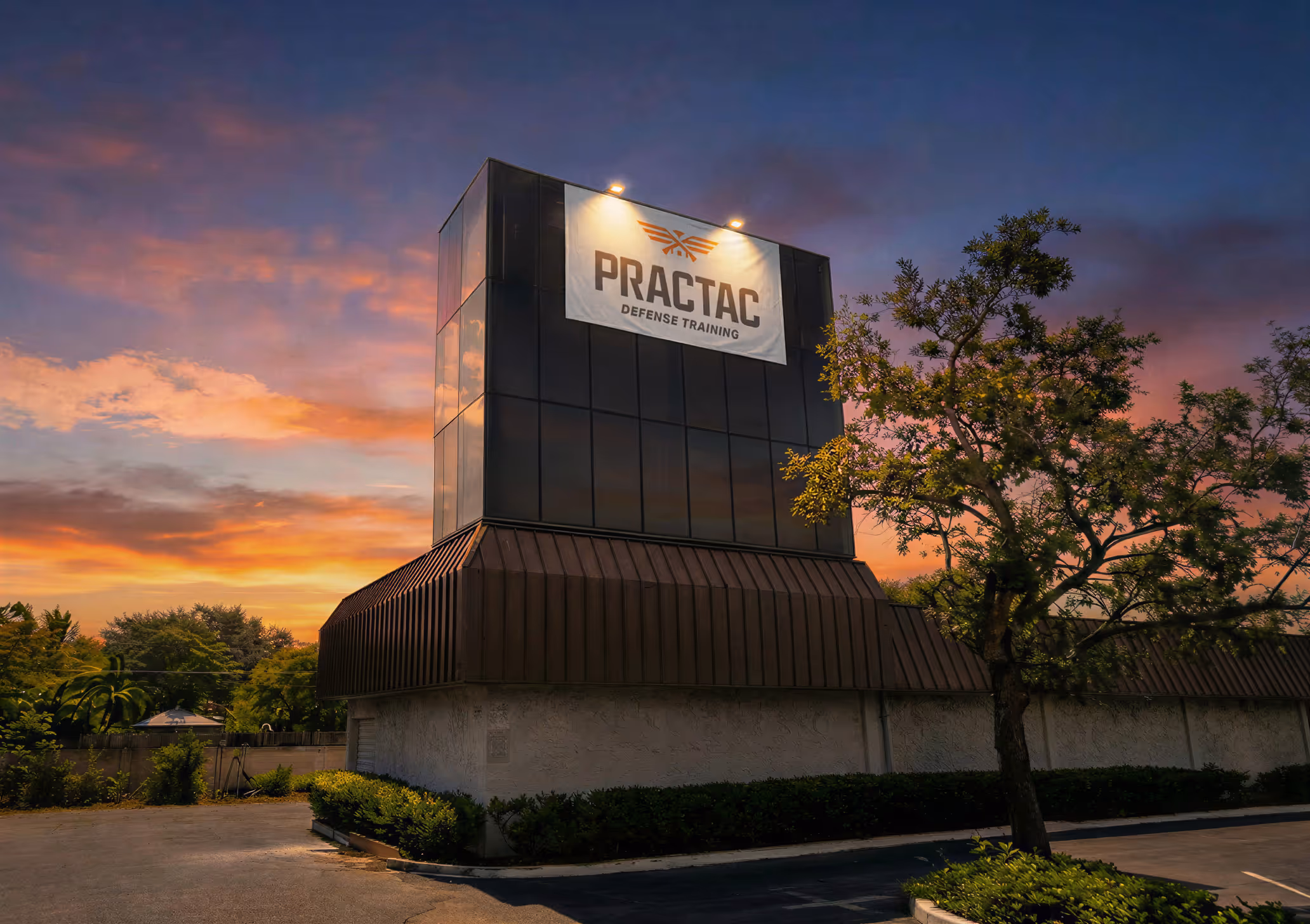 PracTac Defense Training building exterior with illuminated signage at sunset.