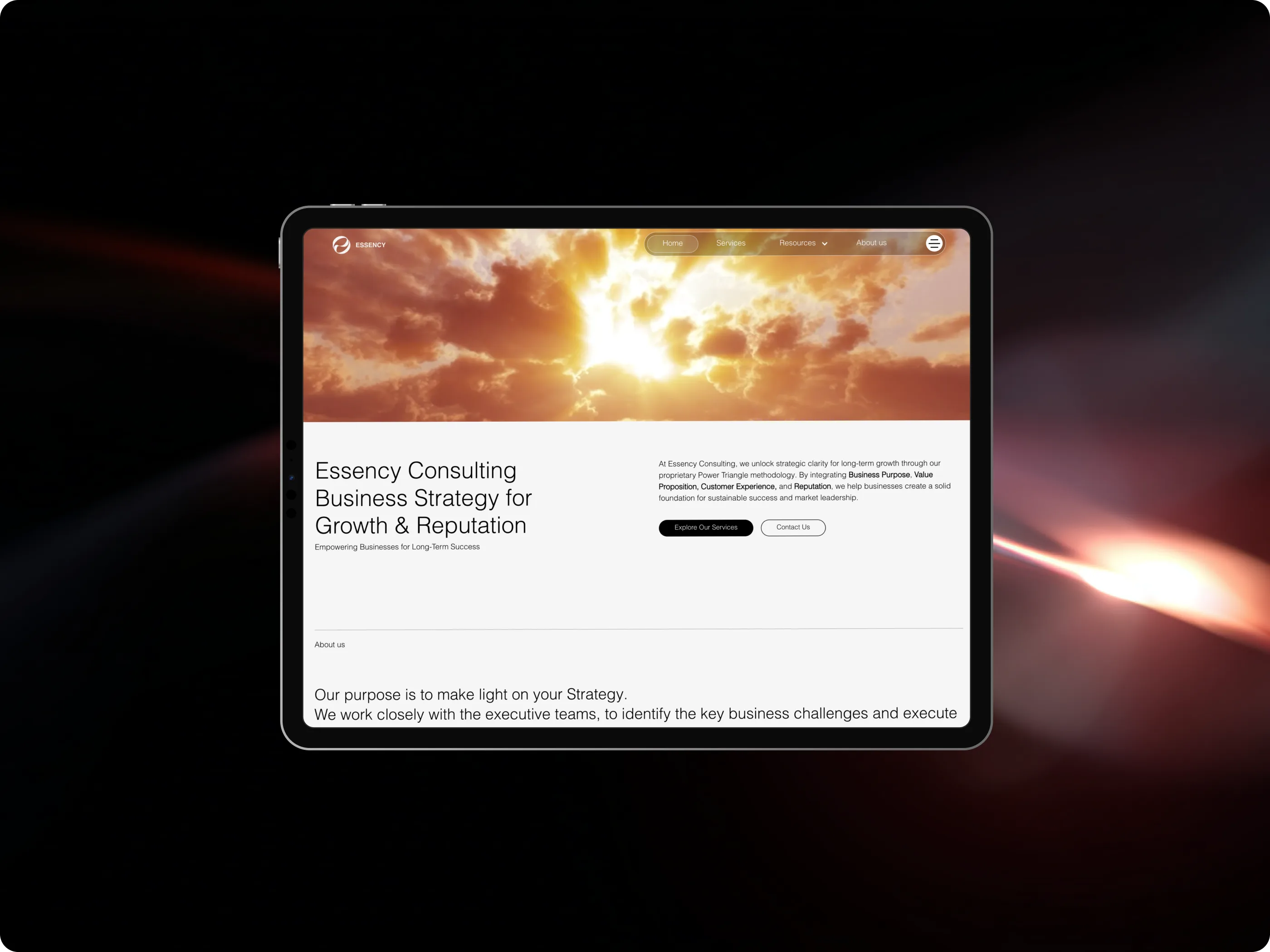 The new Essency website on an iPad, against a dark background with streaks of light