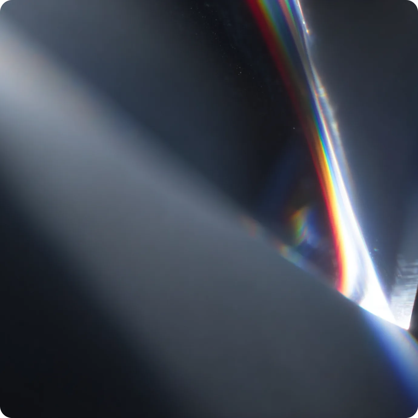 Light refracting through glass into a thin rainbow edge