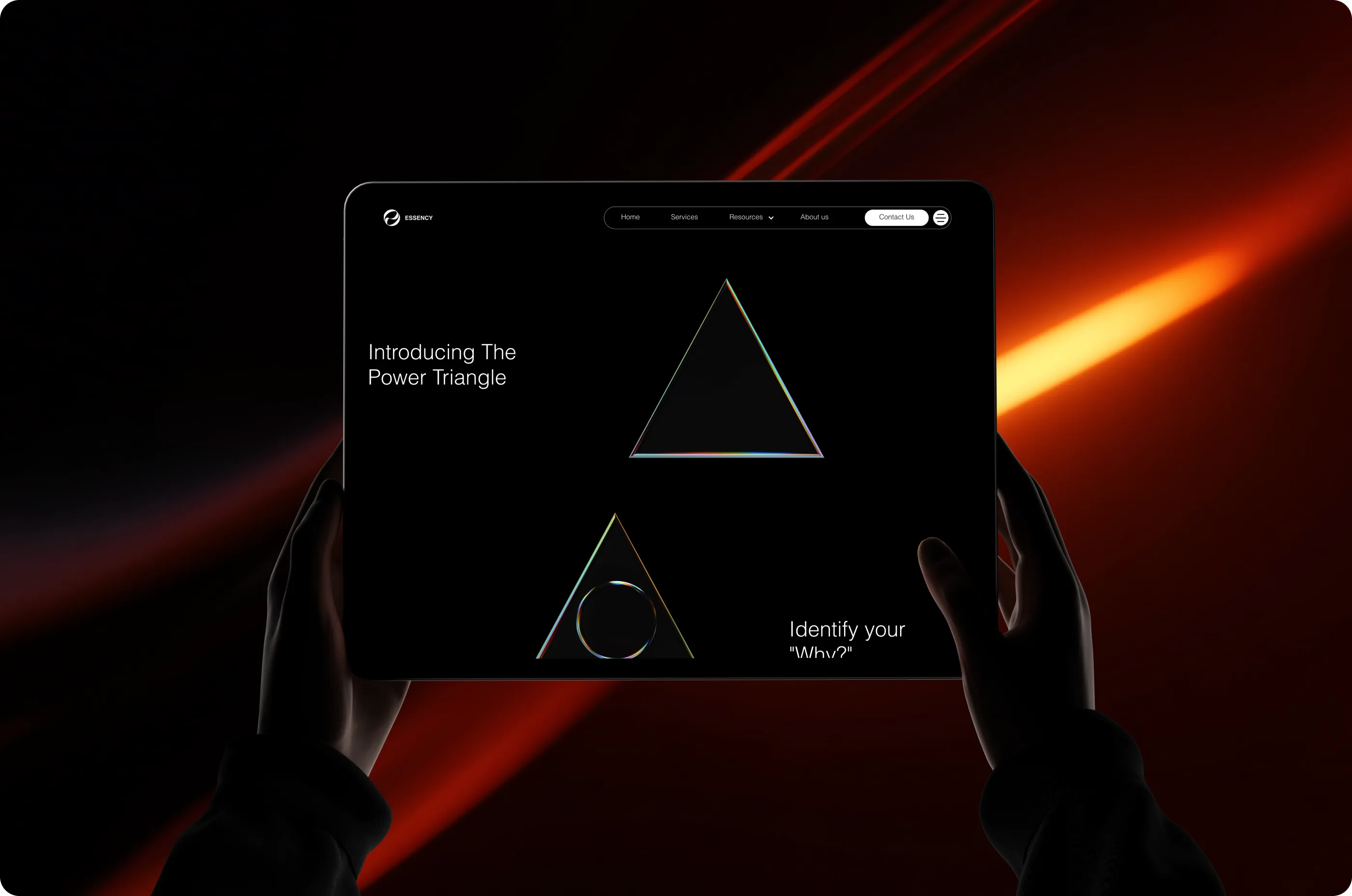 Hands holding a tablet showing the Power Triangle page, against red light