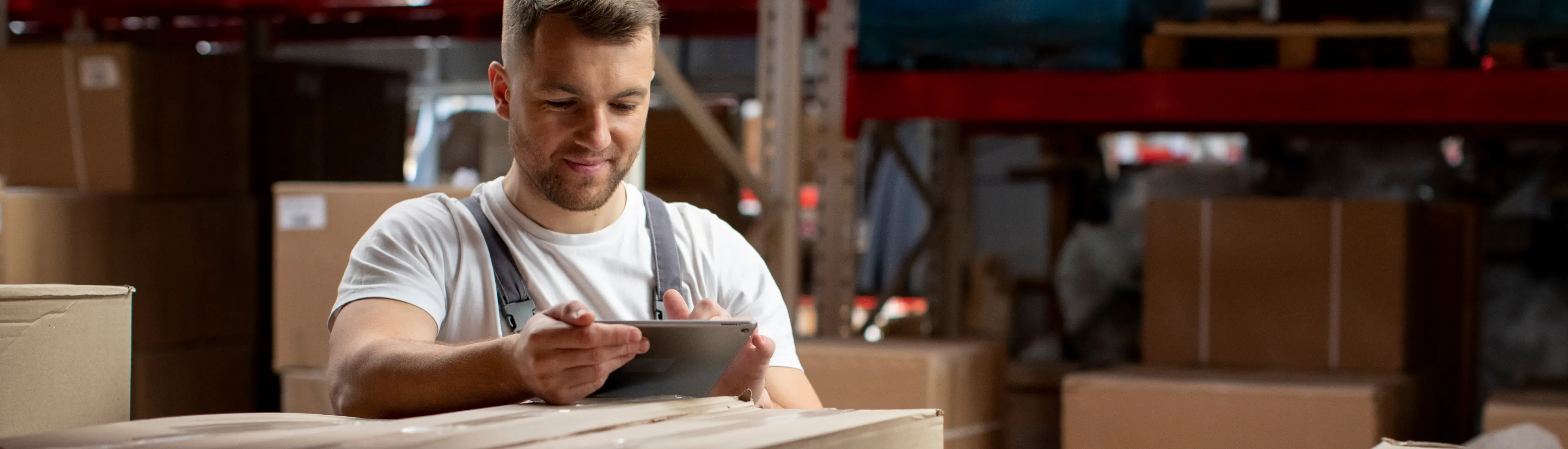 Expert waits ready to take contact calls about Northstar's HVAC/R questions. Holds tablet in warehouse.