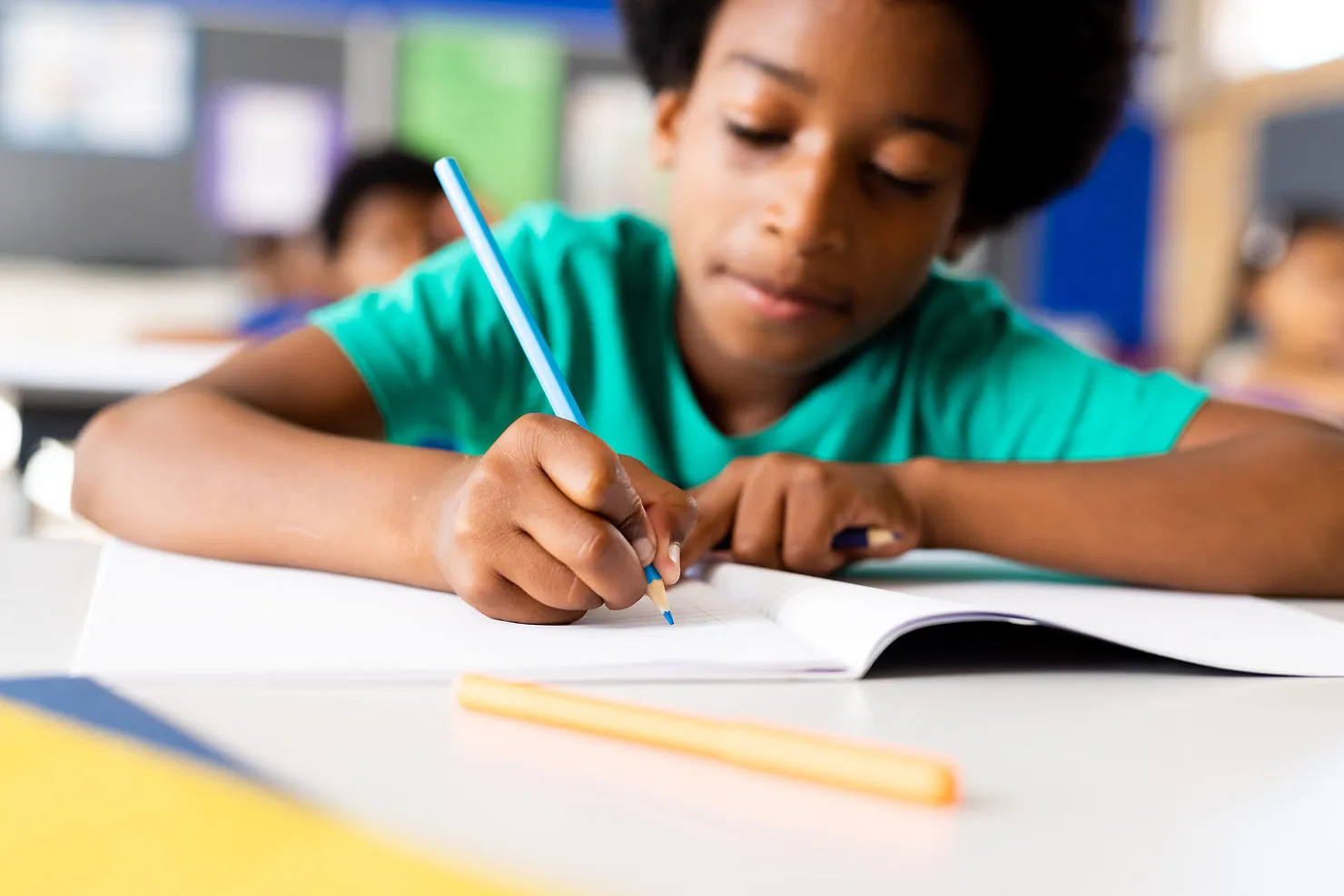 young-boy-writing-on-notebook-tips-for-writing-success-online-writing-tutors-for-kids-edge-tutor