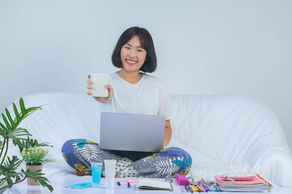 Asian woman in her house enjoying the benefits of working online