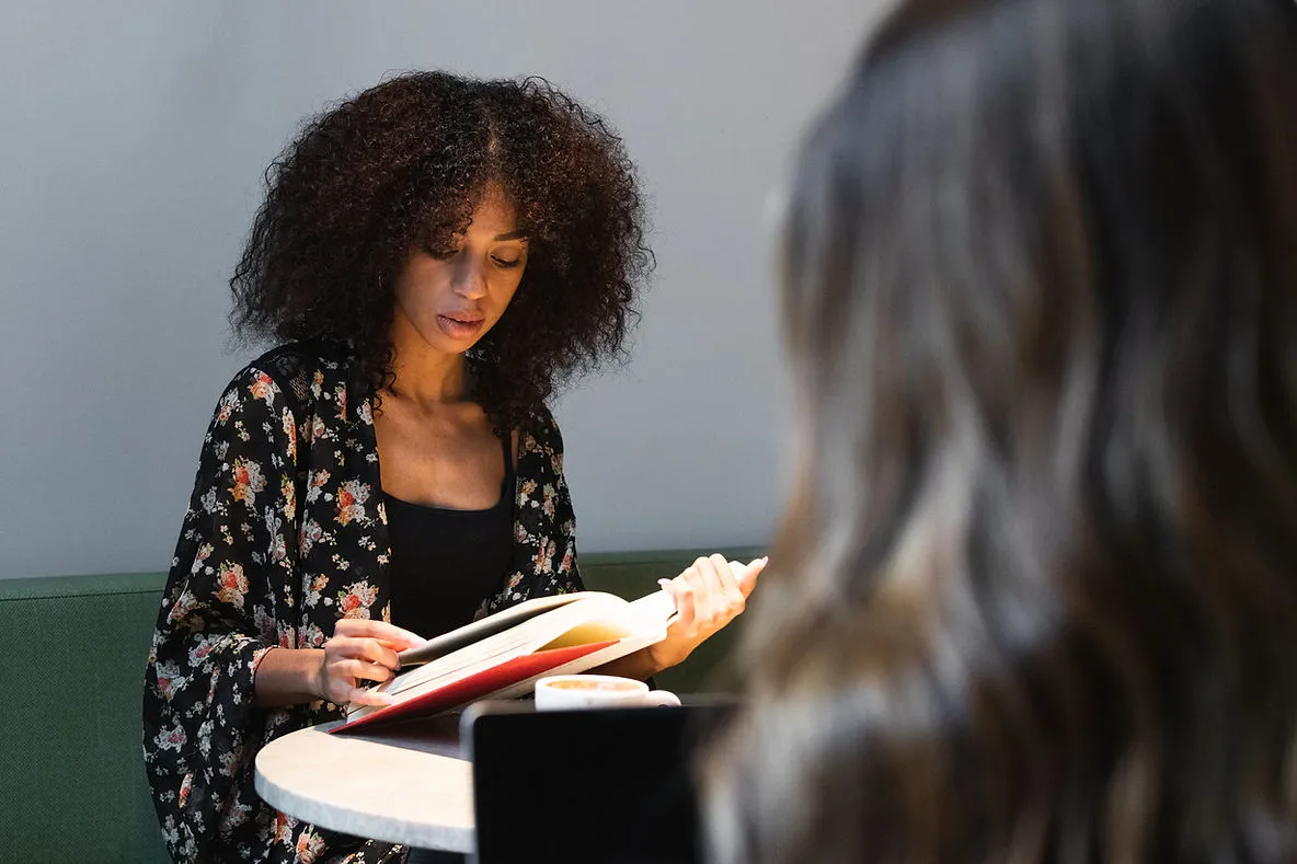 woman-reading-in-cafe-daily-habits-to-improve-your-vocabulary-edge-tutor