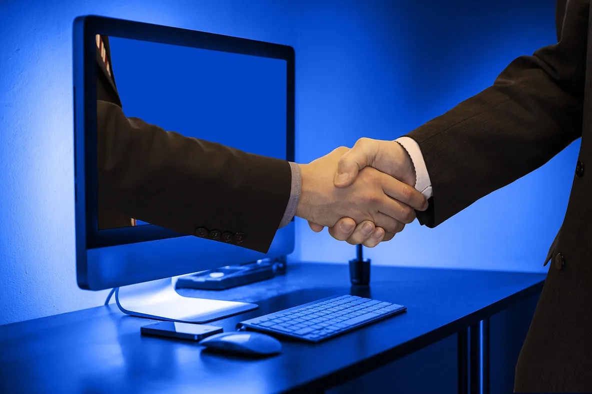 two business men creating a strong B2B partnership in online education through a virtual handshake