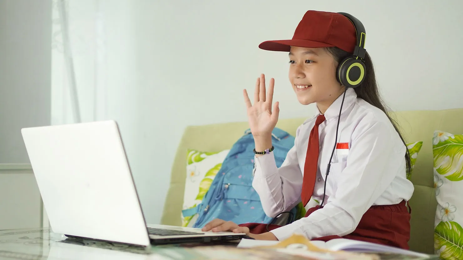 young-girl-waving-on-webcam-how-to-use-roleplay-to-improve-speaking-skills-in-1-1-esl-lessons-edge-tutor
