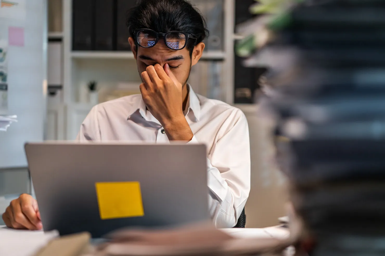 exhausted-man-using-laptop-working-in-office-the-role-of-automation-in-reducing-tutor-burnout-and-increasing-satisfaction-edge-tutor