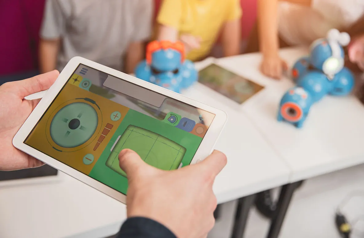 a child holding a mobile device with a colorful word game learns through gamification
