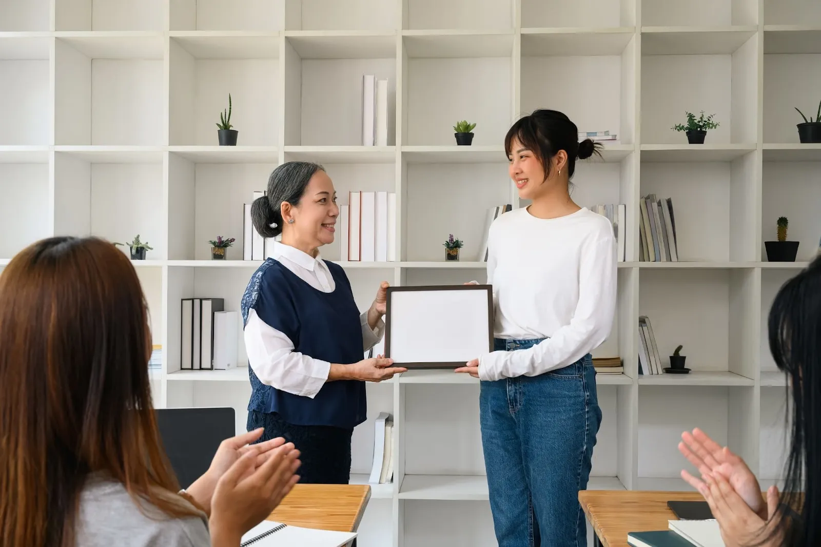 middle-aged-woman-awarding-certificate-to-young-woman-what-are-the-top-esl-certifications-in-2025-edge-tutor