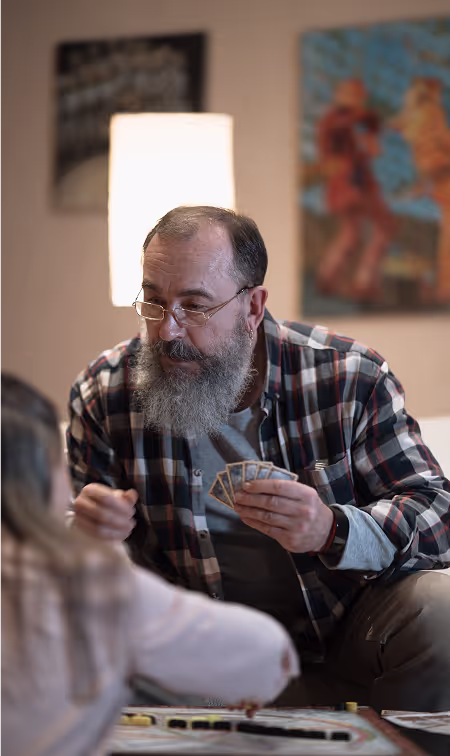 Grandfather playing cards with his granddaughter