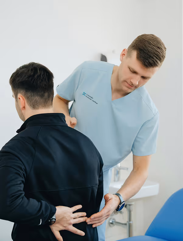Doctor examining a patient's back