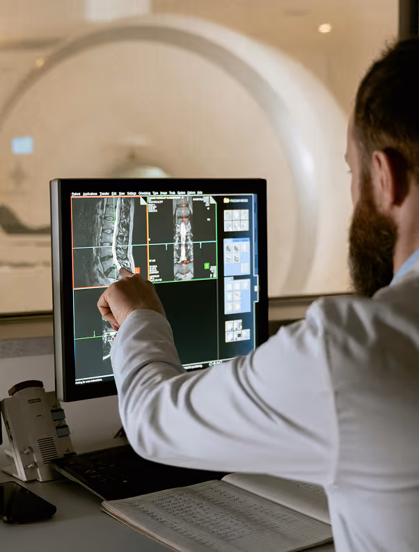 Doctor pointing at x-ray on monitor