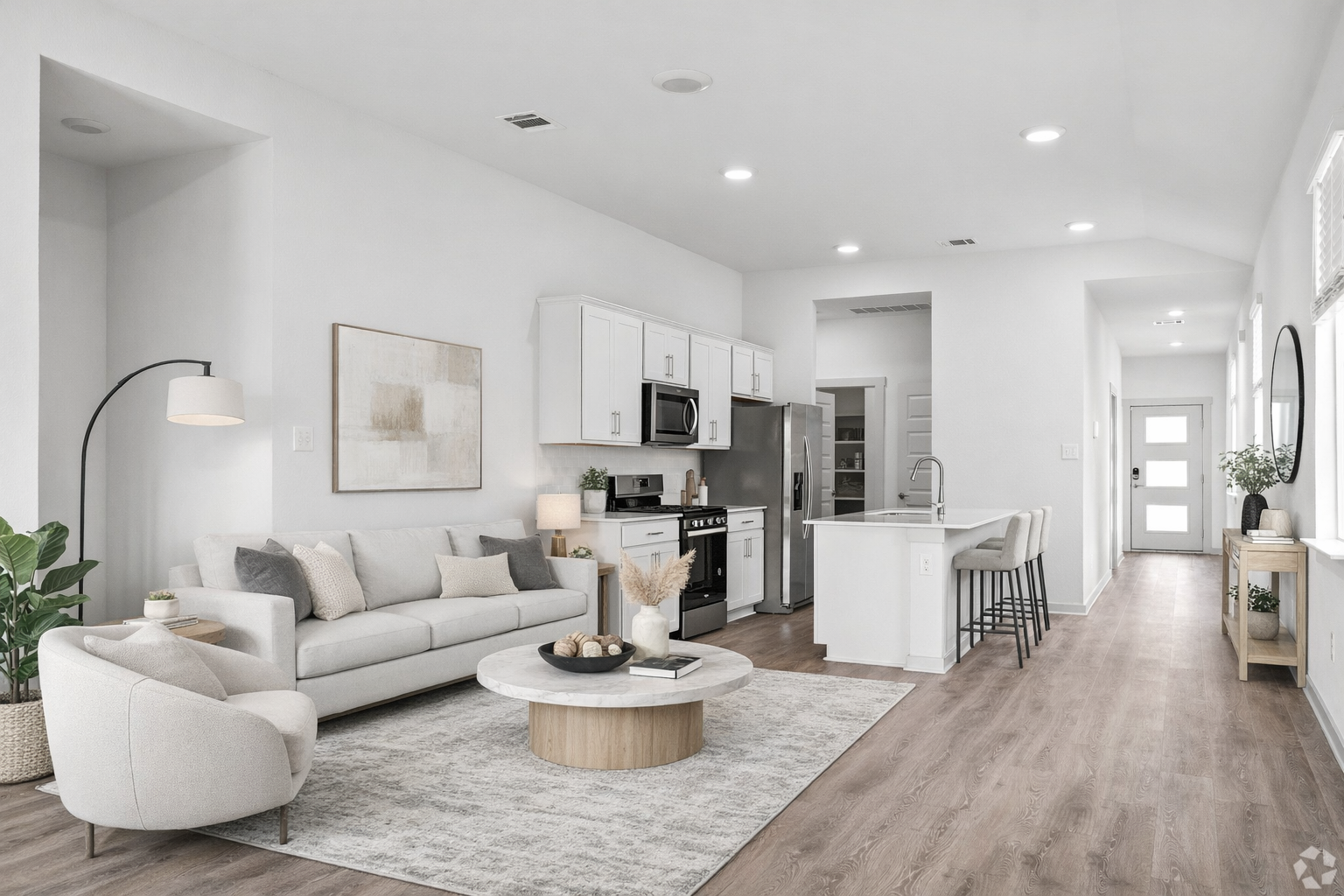 view of kitchen with stainless steel appliances and view of living area with sofa and rug