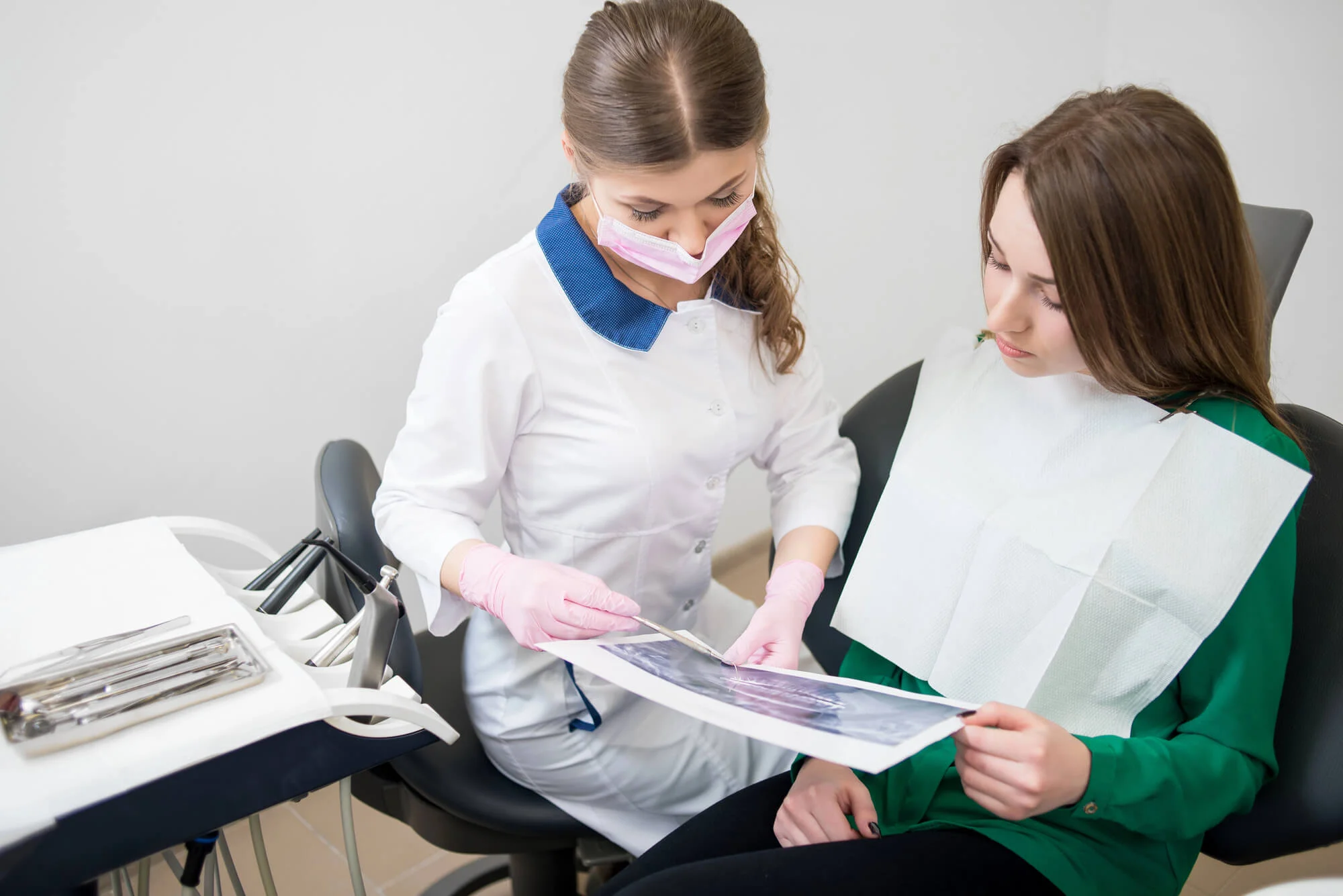 Dentist reviewing dental x-ray with patient Dentist in Palmetto St