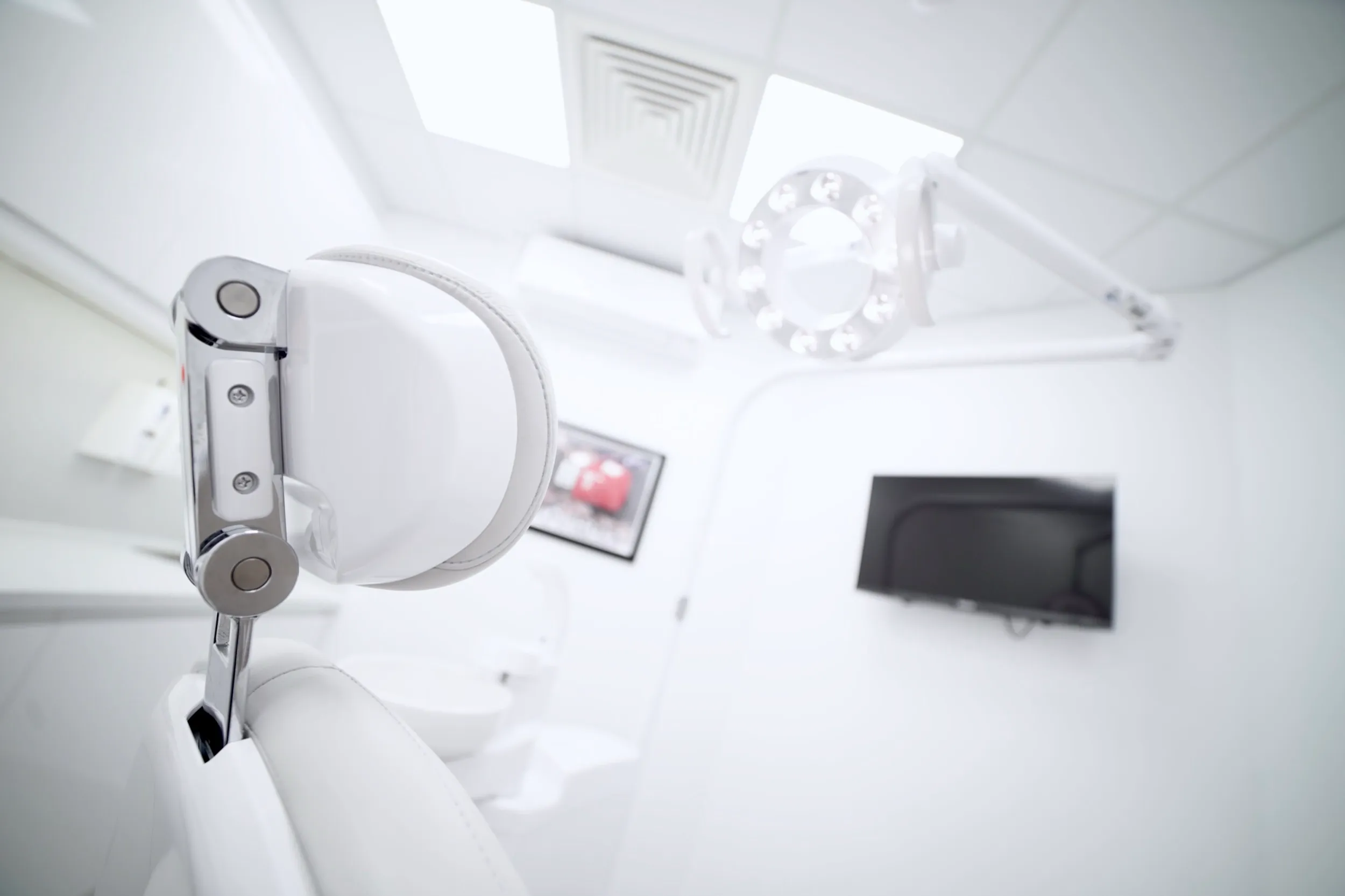 White dental chair and equipment in clean, modern medical office