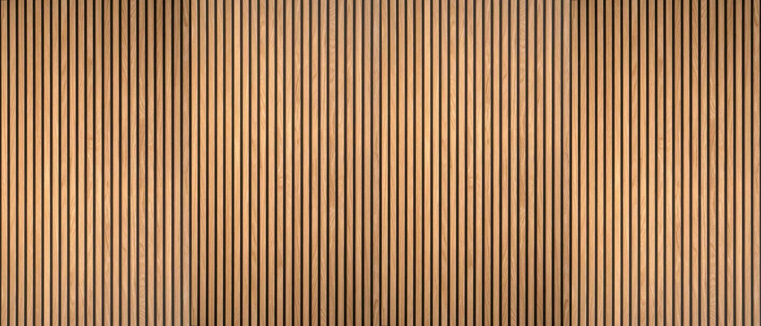 Close-up of vertical wooden panels with narrow black gaps between them, showing wood grain texture in light brown color.