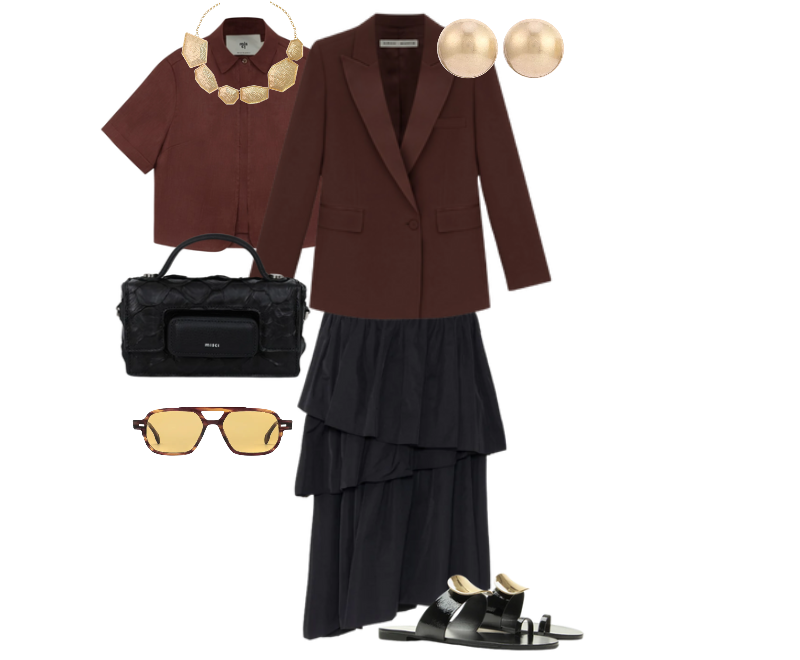 blazer marrom, camisa cropped marrom, saia preta fluida em camadas, sandálias pretas de couro com detalhes metalizados, bolsa preta texturizada, óculos de sol com lentes douradas, brincos dourados, colar statement dourado