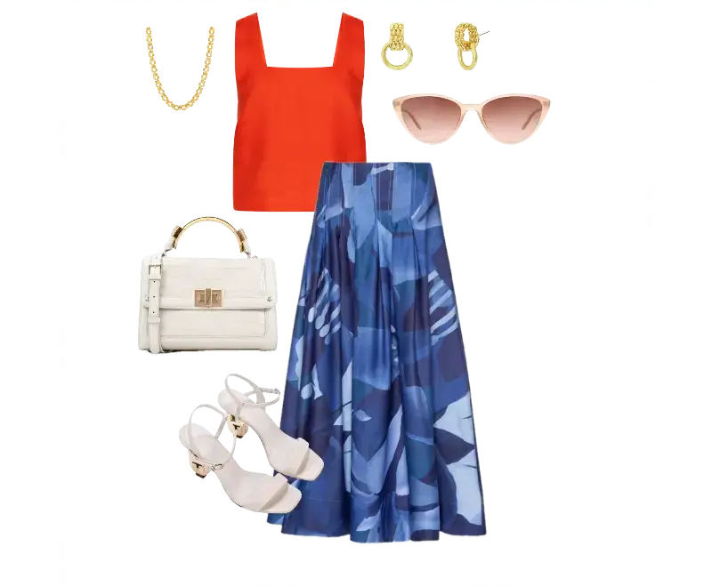 cropped vermelho vibrante, saia longa fluida com estampa abstrata azul, sandálias nude de salto, brincos dourados, colar dourado, bolsa estruturada branca, óculos de sol