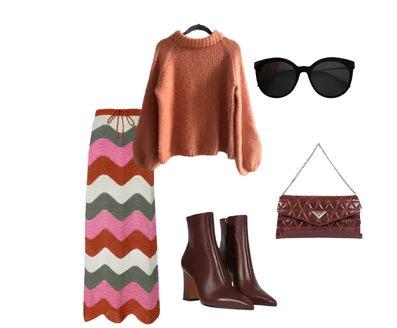 Suéter oversized terracota em tricô, Saia longa estampada zigue-zague multicolorido, Botas de couro marrom com salto grosso, Bolsa transversal vinho texturizada, Óculos de sol oversized preto