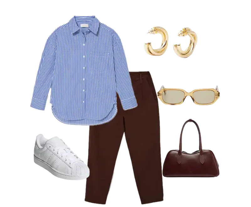 Camisa listrada azul e branca, calça marrom de corte reto, tênis brancos, bolsa estruturada de couro marrom escuro, brincos de argola dourados, óculos de sol com armação bege