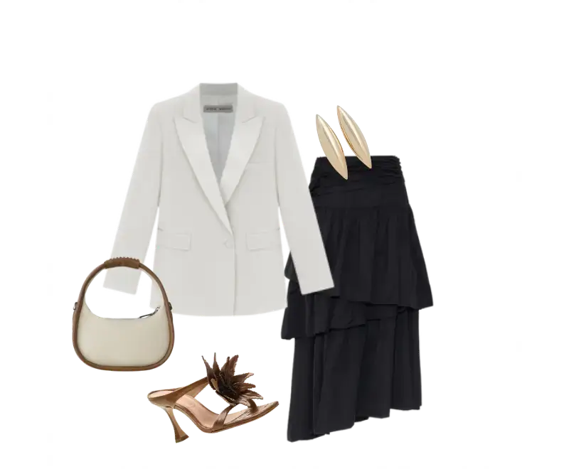 blazer branco de alfaiataria, saia preta em camadas longa e fluida, sandálias de salto marrons com detalhes ornamentais, brincos dourados ovais, bolsa em couro off-white com alça marrom