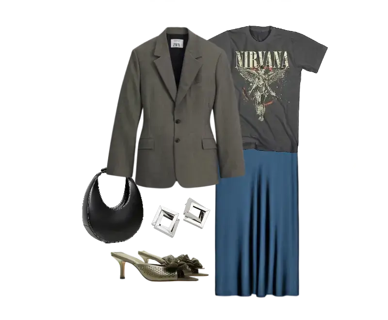blazer oversized cinza da Zara, camiseta preta com estampa da banda Nirvana, saia midi azul fluida, mules de salto médio bege com detalhes metálicos, bolsa preta de couro formato meia-lua, brincos geométricos prateados