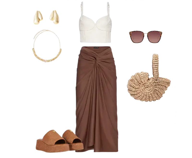 top cropped em renda off-white, saia longa marrom drapeada, plataformas de palha trançada, bolsa de mão em palha espiralizada, óculos de sol retrô, brincos dourados, colar corrente