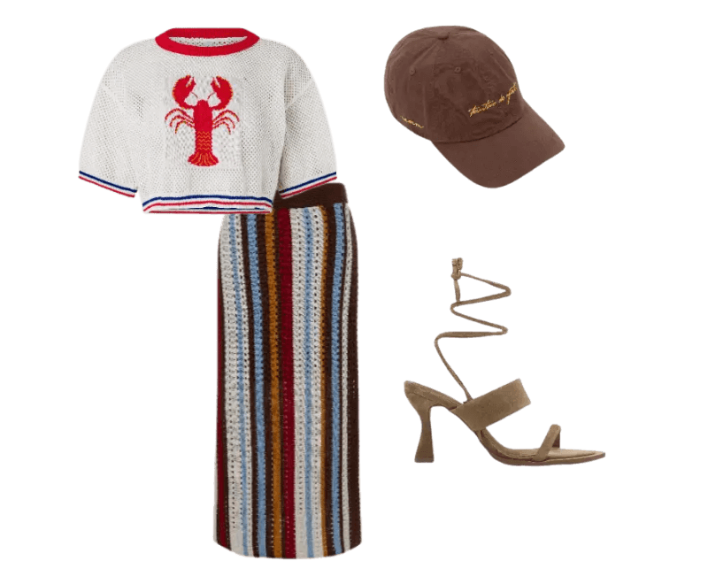 suéter branco estampa lagosta, saia longa listrada multicolorida, boné marrom, sandálias bege de salto.