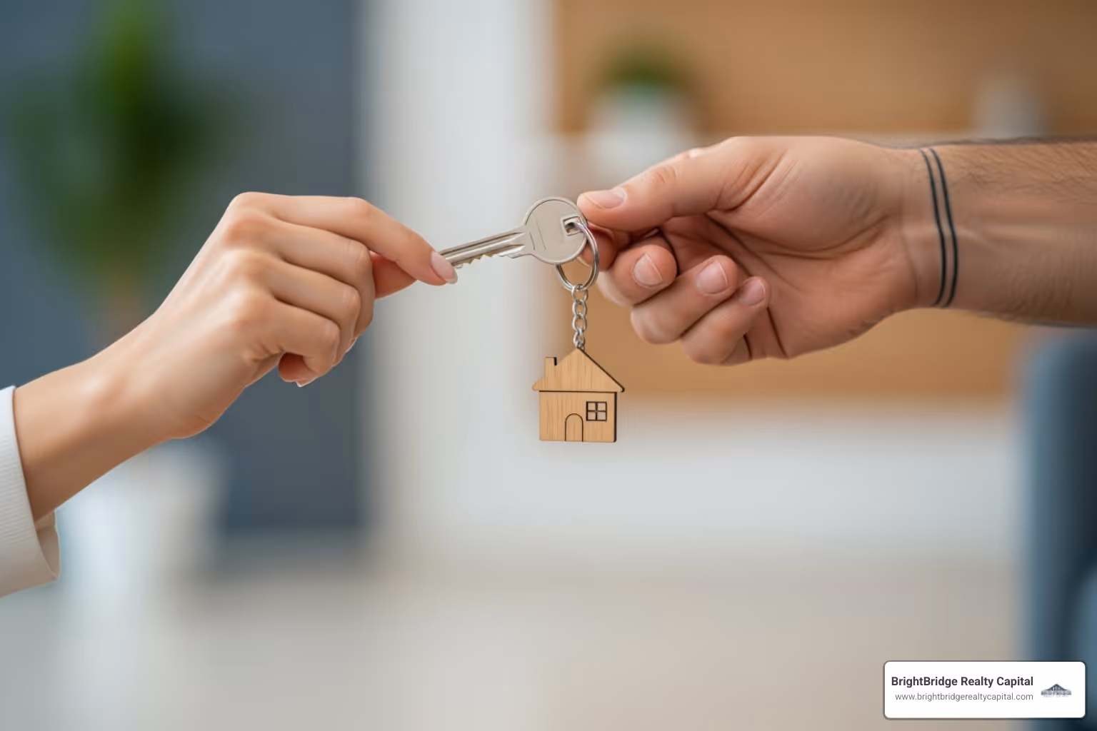 keys with a keychain shaped like a house being handed to someone - how to finance a short term rental