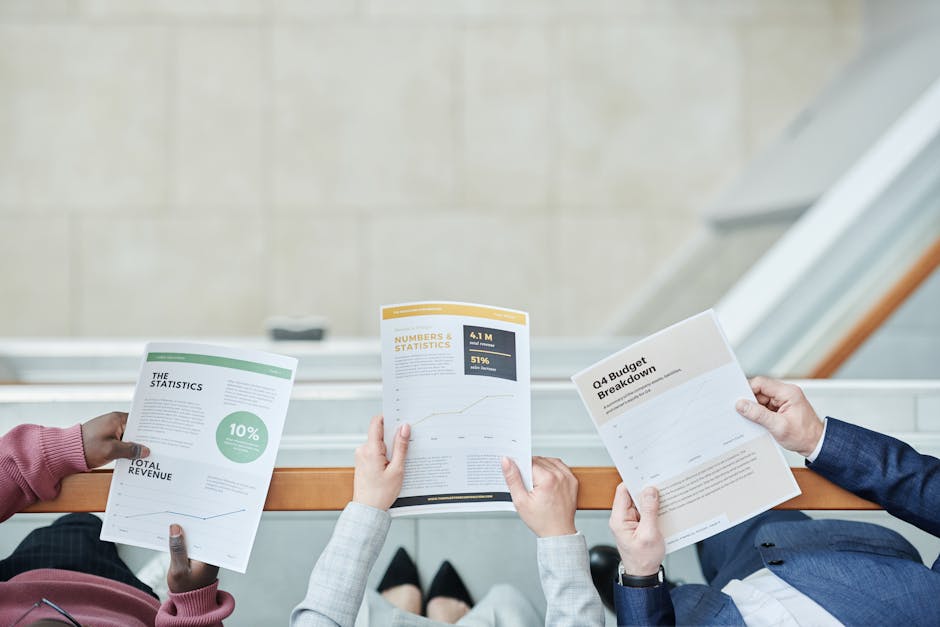 An investor meeting with a loan officer, reviewing documents. - property acquisition loan