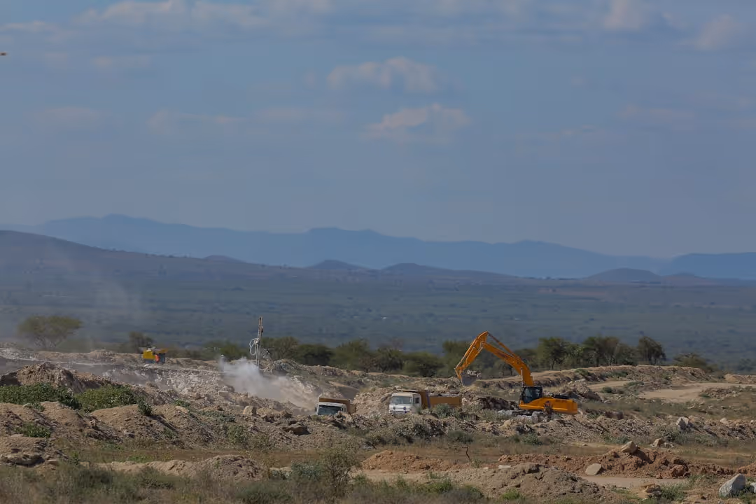 A plot of land being cleared by construction equipment - land development loan